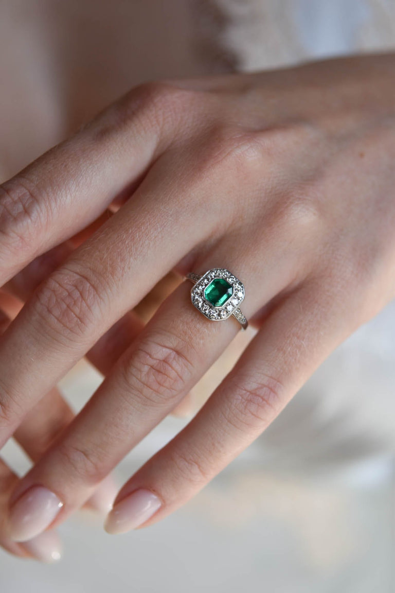 Art Deco .60 Carat Octagonal Columbian Emerald and Diamond Platinum Vintage Engagement Ring on a hand